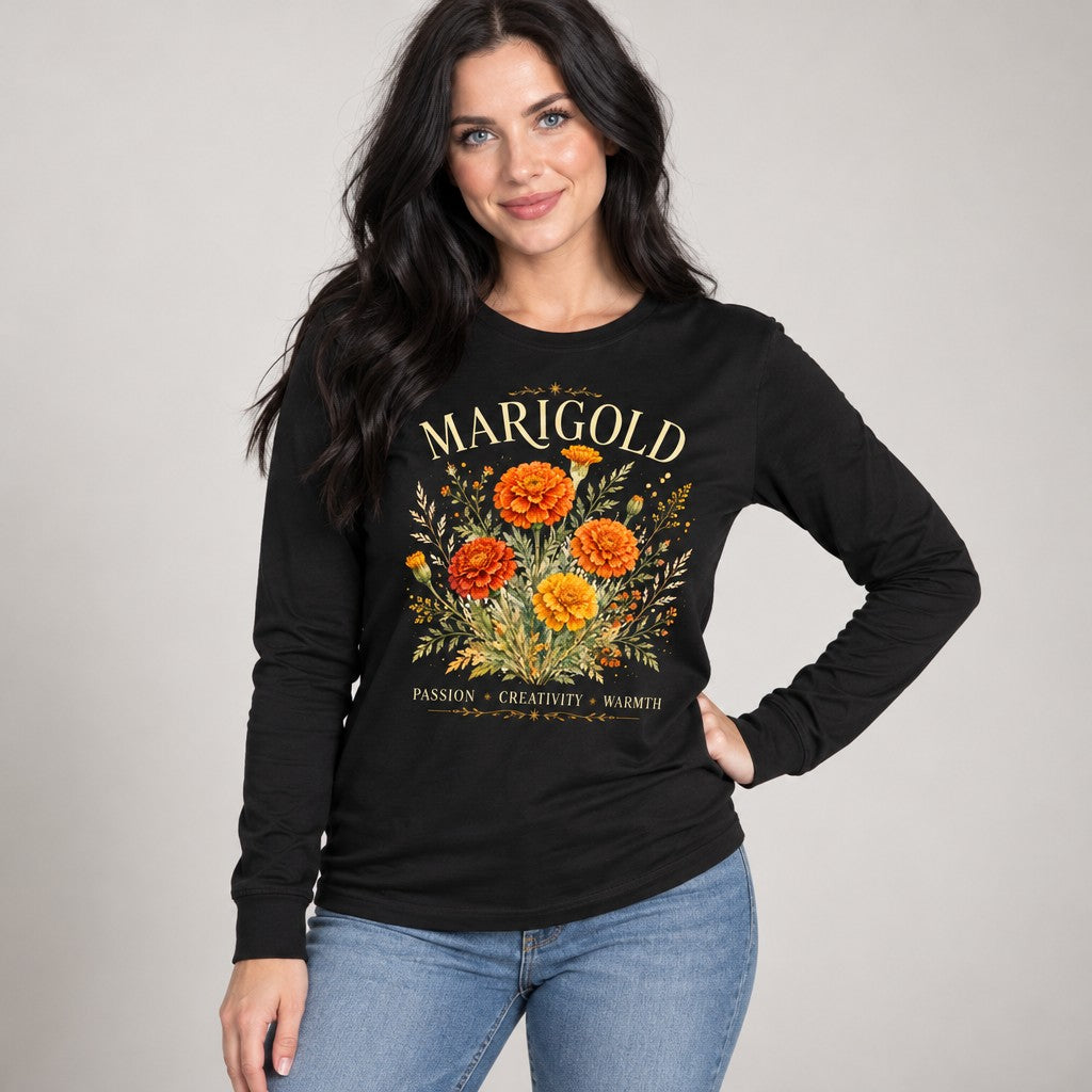 Woman wearing black Bella Canvas® 3501 long sleeve shirt with vintage watercolor marigold floral bouquet design, featuring gold and orange flowers, botanical style text 'MARIGOLD', autumn colors, perfect for October birthdays, flower symbolism enthusiasts, and gardeners, by Crossroads Dandelion