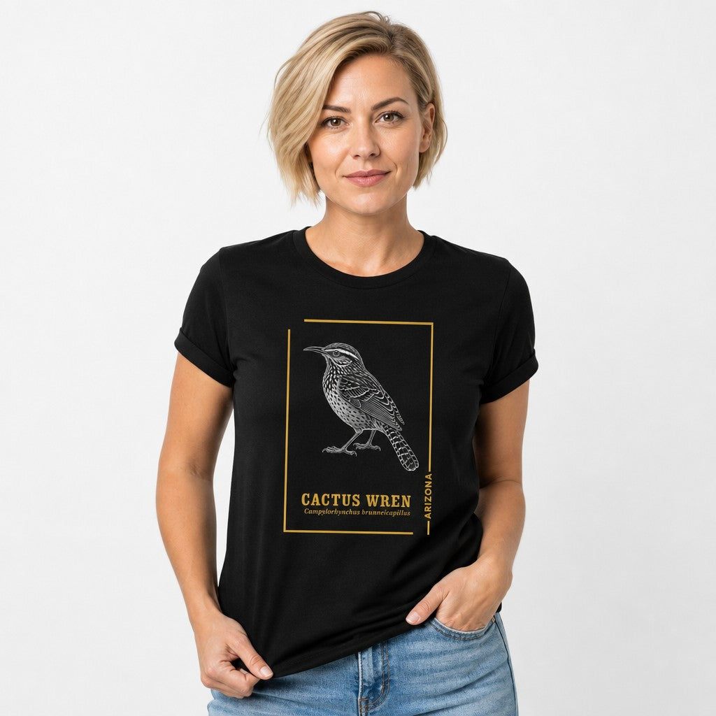 Woman in black Bella Canvas 3001 t-shirt featuring a hand-drawn line art Cactus Wren and vintage botanical journal accents, Arizona state bird design for ornithology lovers, retro desert field guide style, by Crossroads Dandelion