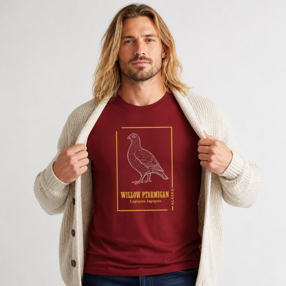Man wearing a cardinal red Bella Canvas 3001 t-shirt with a vintage hand-drawn willow ptarmigan and golden botanical frame, inspired by naturalist field journals, perfect for birdwatchers, wildlife enthusiasts, and cottagecore style, by Crossroads Dandelion
