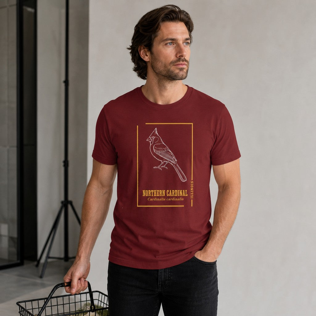 Man in cardinal red Bella Canvas 3001 t-shirt featuring a vintage white line art northern cardinal illustration, minimalist golden frame, and antique botanical typography, perfect for birders and naturalists, modern loft setting, by Crossroads Dandelion