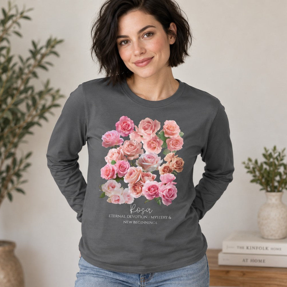 Woman in asphalt Bella Canvas 3501 long sleeve featuring a vintage-inspired watercolor bouquet of pink and blush roses, romantic floral illustration, cottagecore aesthetic, perfect for nature lovers and June birthdays, at home, by Crossroads Dandelion