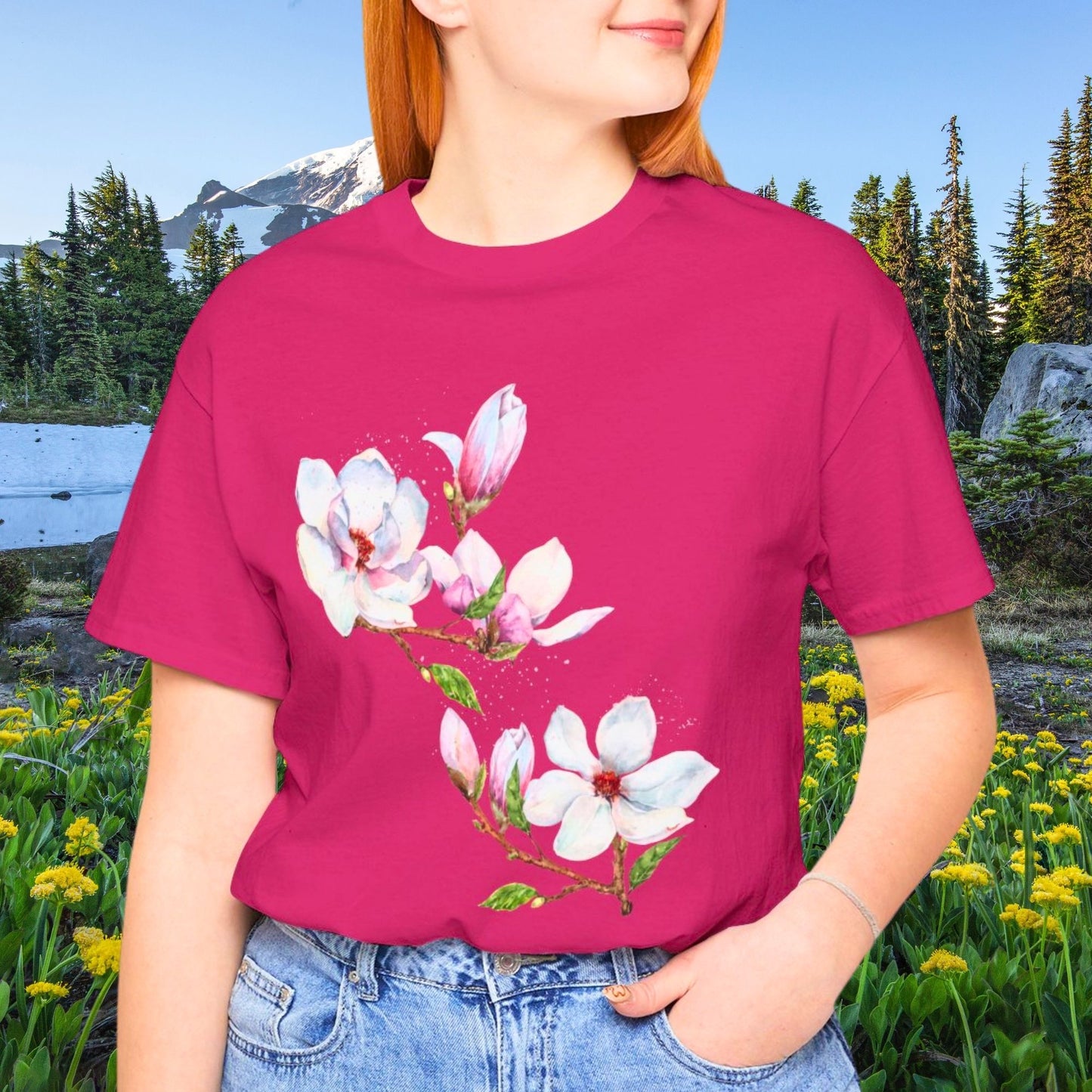 Woman wearing a berry color magnolia flower shirt with watercolor botanical floral design in a nature setting by Crossroads Dandelion
