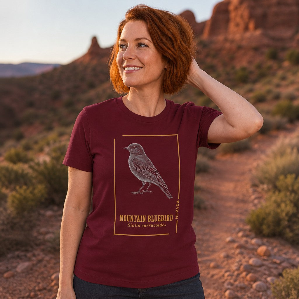 Woman wearing a cardinal t-shirt with a vintage line art mountain bluebird design, hiking on a desert trail, perfect for bird lovers and outdoor enthusiasts, by Crossroads Dandelion