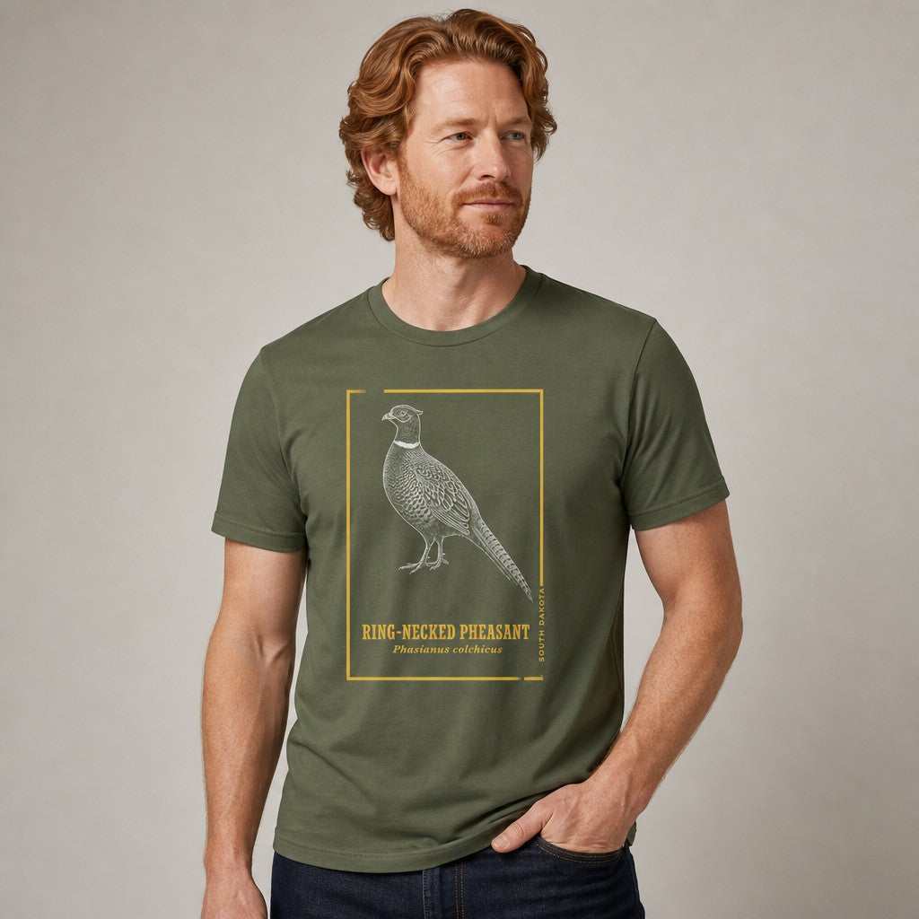 Man wearing a military green Bella Canvas 3001 t-shirt featuring a hand-illustrated vintage style ring-necked pheasant with golden botanical accents and elegant block lettering, ideal for birdwatchers and naturalists, by Crossroads Dandelion