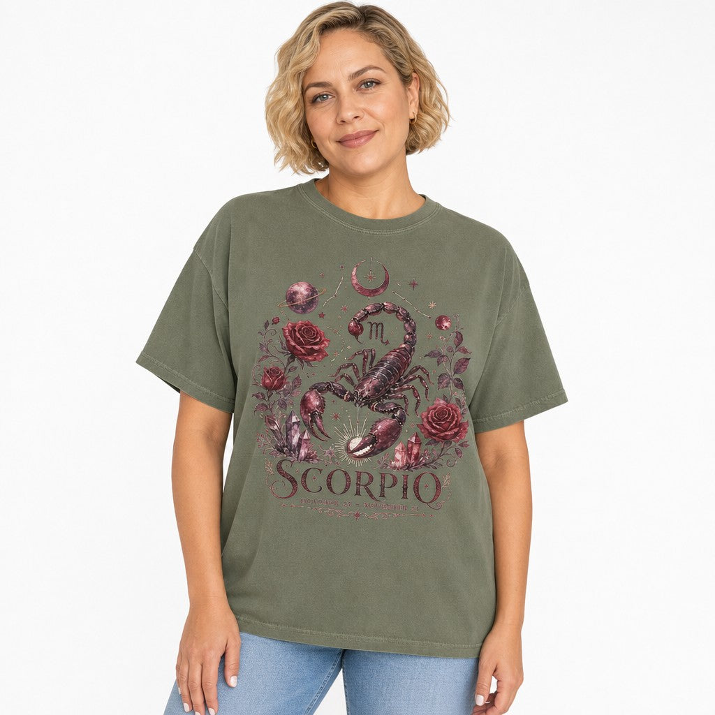 Woman wearing a moss green Comfort Colors t-shirt with a vintage celestial Scorpio design featuring a detailed hand-drawn scorpion surrounded by dark red roses, stars, moons, and crystals, perfect for astrology and zodiac lovers, by Crossroads Dandelion