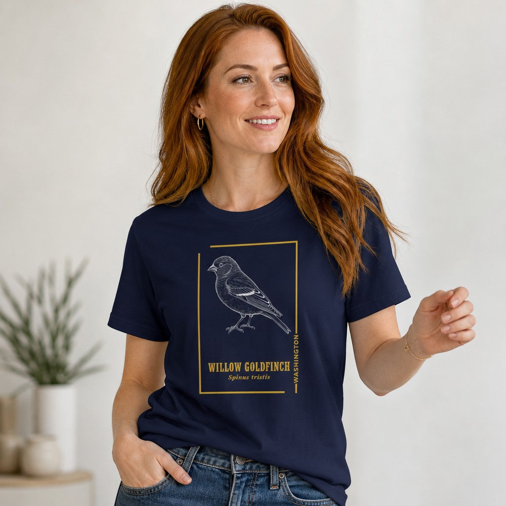 Woman wearing navy Bella Canvas 3001 t-shirt with vintage etching style willow goldfinch bird design, golden accents, classic serif text, perfect for nature lovers and birdwatchers, boutique botanical art aesthetic, by Crossroads Dandelion