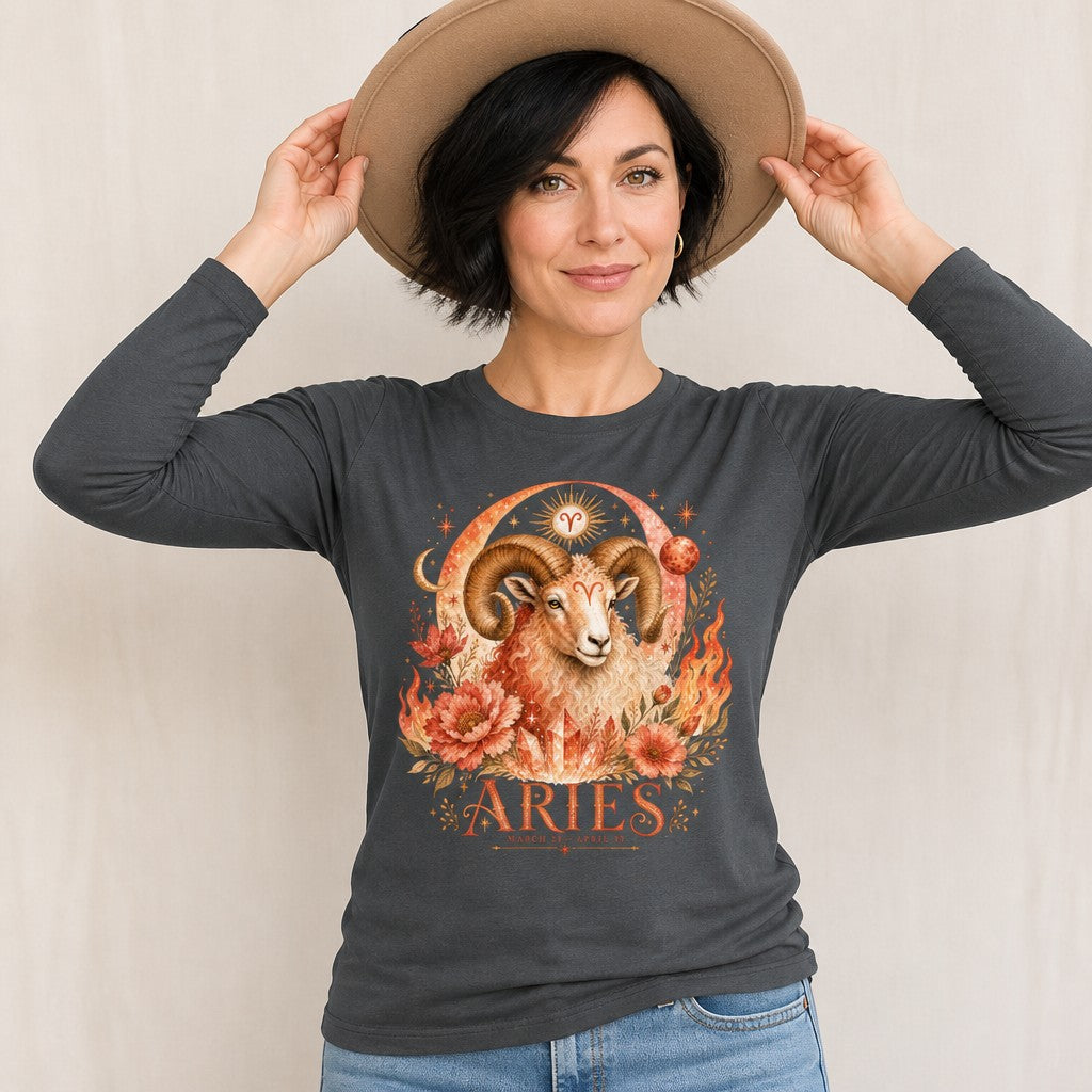 Woman wearing an asphalt Bella Canvas 3501 long sleeve shirt featuring a watercolor Aries ram with grand curling horns, surrounded by fiery florals, sun, moon, and vintage celestial zodiac motifs, poetic astrology design for women, by Crossroads Dandelion