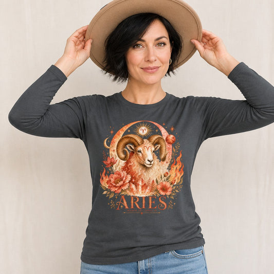 Woman wearing an asphalt Bella Canvas 3501 long sleeve shirt featuring a watercolor Aries ram with grand curling horns, surrounded by fiery florals, sun, moon, and vintage celestial zodiac motifs, poetic astrology design for women, by Crossroads Dandelion