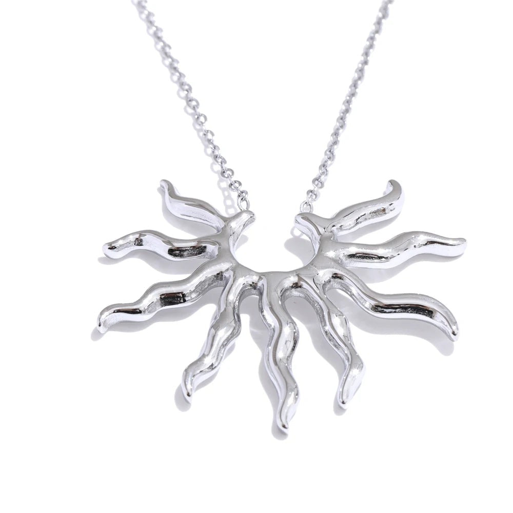 Silver-tone wavy sun pendant necklace on a fine cable chain, front view on white