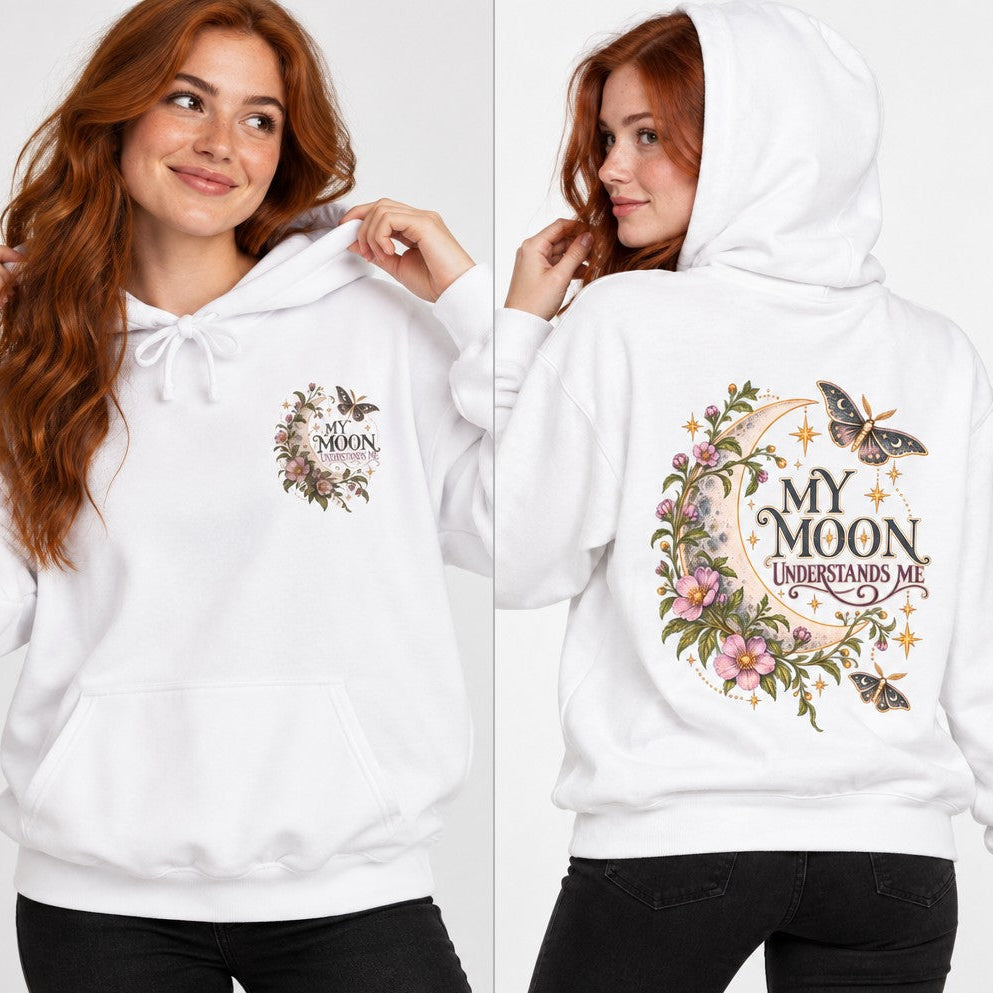 White hoodie with whimsical floral moon and butterfly illustration, 'My Moon Understands Me' text, worn by a red-haired woman, cottagecore style for women who love mystical and dreamy designs, by Crossroads Dandelion